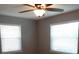 Cozy bedroom with a ceiling fan, two windows, and neutral paint tones at 1014 Lexington St, Lakeland, FL 33801