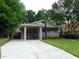 Attractive home with a spacious front yard, driveway, and covered parking area at 1014 Lexington St, Lakeland, FL 33801