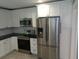 Modern kitchen featuring stainless steel appliances, white cabinets, and dark countertops at 1014 Lexington St, Lakeland, FL 33801