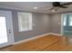 Bright living room featuring hardwood floors, a ceiling fan, and large windows at 1014 Lexington St, Lakeland, FL 33801