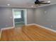 Spacious living room showcasing hardwood floors and neutral gray paint at 1014 Lexington St, Lakeland, FL 33801