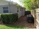 A tranquil side yard with wood fencing and mature landscaping at 1014 Lexington St, Lakeland, FL 33801