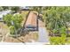 Aerial view showcases this charming home with mature trees, long driveway and fenced yard at 1105 Terry S Ave, Lakeland, FL 33815