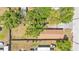 Aerial view of home with mature trees, fenced yard and adjacent properties at 1105 Terry S Ave, Lakeland, FL 33815