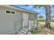 Home's exterior features a back entrance with well maintained steps, railing and garden decor at 1105 Terry S Ave, Lakeland, FL 33815