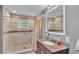 Bathroom with a glass-enclosed shower and granite countertop at 1105 Terry S Ave, Lakeland, FL 33815