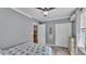 Bedroom featuring a ceiling fan and a closet with folding doors at 1105 Terry S Ave, Lakeland, FL 33815