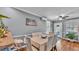 Bright dining room with hardwood floors, gray walls, modern ceiling fan, and access to the backyard at 1105 Terry S Ave, Lakeland, FL 33815