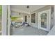 Inviting covered front porch with comfortable seating, gray wood deck, and decorative floral accents at 1105 Terry S Ave, Lakeland, FL 33815