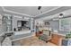 Open-concept living room showcasing custom built-in shelving, hardwood floors and access to the dining area at 1105 Terry S Ave, Lakeland, FL 33815