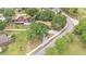 A bird's-eye view showcases the house with a long driveway surrounded by lush greenery at 1205 Scottsland Dr, Lakeland, FL 33813