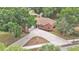 An all brick home with a long driveway and mature trees on a well manicured lawn at 1205 Scottsland Dr, Lakeland, FL 33813