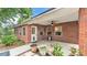 Covered patio with red brick, ceiling fan, and backyard access at 1205 Scottsland Dr, Lakeland, FL 33813