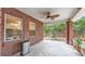 Relaxing covered back patio with brick walls and view of backyard at 1205 Scottsland Dr, Lakeland, FL 33813
