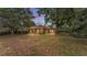 Expansive backyard featuring a well-maintained lawn and mature trees, ideal for outdoor activities and relaxation at 1205 Scottsland Dr, Lakeland, FL 33813