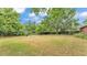 Well-maintained lawn, trees, and lush greenery fill the property's backyard at 1205 Scottsland Dr, Lakeland, FL 33813