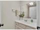 Bright bathroom featuring a clean white vanity and mirrored wall at 1205 Scottsland Dr, Lakeland, FL 33813