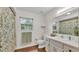 Bathroom with a patterned shower curtain, a single sink vanity, and a window for natural light at 1205 Scottsland Dr, Lakeland, FL 33813