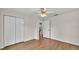 Bedroom featuring wood floors and white closet doors for ample storage space at 1205 Scottsland Dr, Lakeland, FL 33813