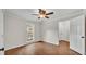 Bright bedroom with laminate flooring, a window, and an open doorway at 1205 Scottsland Dr, Lakeland, FL 33813