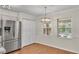 Bright dining area features a stainless steel refrigerator, and modern lighting at 1205 Scottsland Dr, Lakeland, FL 33813