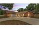 Brick home showcasing a wide driveway and two car garage at 1205 Scottsland Dr, Lakeland, FL 33813