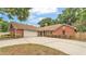 Charming brick home featuring an attached garage and well-manicured landscaping at 1205 Scottsland Dr, Lakeland, FL 33813