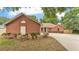 Charming single-story brick home with a well-maintained lawn and a curved driveway at 1205 Scottsland Dr, Lakeland, FL 33813