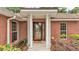 All brick home featuring a craftsman style front door and mature landscaping at 1205 Scottsland Dr, Lakeland, FL 33813