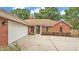 All brick home with a manicured front yard and a two car garage at 1205 Scottsland Dr, Lakeland, FL 33813
