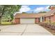 A well-maintained home featuring a two-car garage and brick facade at 1205 Scottsland Dr, Lakeland, FL 33813