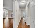 Hallway with wood floors leading to multiple rooms, showing the home's layout at 1205 Scottsland Dr, Lakeland, FL 33813