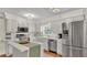 Classic kitchen design with white cabinetry, stainless steel appliances, and a center island at 1205 Scottsland Dr, Lakeland, FL 33813