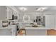 A well-lit, cozy kitchen featuring white cabinets and stainless steel appliances at 1205 Scottsland Dr, Lakeland, FL 33813
