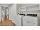 Laundry area with a washer and dryer, laminate flooring, and storage shelves at 1205 Scottsland Dr, Lakeland, FL 33813