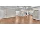 Open concept living room with hardwood floors connected to the kitchen and fireplace at 1205 Scottsland Dr, Lakeland, FL 33813