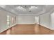 Bright living room with hardwood floors, large windows, and a neutral color palette at 1205 Scottsland Dr, Lakeland, FL 33813