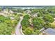 A scenic neighborhood view featuring tree-lined streets and glimpses of a lake in the distance at 1205 Scottsland Dr, Lakeland, FL 33813