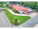 Aerial shot showcasing a home with a red roof, extensive landscaping, and a spacious driveway at 1407 Easton Dr, Lakeland, FL 33803
