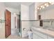 Bathroom featuring white toilet, vanity with drawers, mirror with Hollywood lights, and shower stall at 1407 Easton Dr, Lakeland, FL 33803