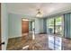 Light-filled bedroom with ample windows, a ceiling fan, and mirrored closet for added convenience at 1407 Easton Dr, Lakeland, FL 33803