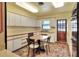 Cozy kitchen with white cabinets, updated appliances, and a functional breakfast nook area at 1407 Easton Dr, Lakeland, FL 33803