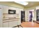 Efficient kitchen layout with built-in oven and microwave, and generous countertop space at 1407 Easton Dr, Lakeland, FL 33803