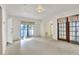 Bright living room with terrazzo floors, large windows, and open access to other rooms at 1407 Easton Dr, Lakeland, FL 33803