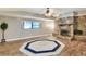 Spacious living area with a decorative stone fireplace, and large windows for natural light at 1407 Easton Dr, Lakeland, FL 33803