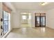 Spacious living room with an open floorplan and hardwood glass paneled doors leading outside at 1407 Easton Dr, Lakeland, FL 33803