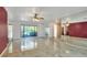 Bright living room featuring tile floors, mirrored accents, and large windows overlooking greenery at 1407 Easton Dr, Lakeland, FL 33803