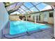 Enclosed in-ground pool with a screened enclosure providing a private and serene outdoor space at 1407 Easton Dr, Lakeland, FL 33803