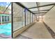 Outdoor pool area showcases a lattice privacy fence, access to pool and concrete walkway at 1407 Easton Dr, Lakeland, FL 33803