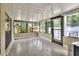 Light-filled sunroom featuring expansive windows offering views of the surrounding greenery and garden at 1407 Easton Dr, Lakeland, FL 33803